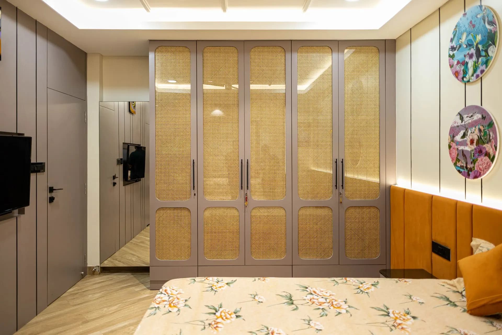 After renovation — modern bedroom with cane wardrobe and warm lighting